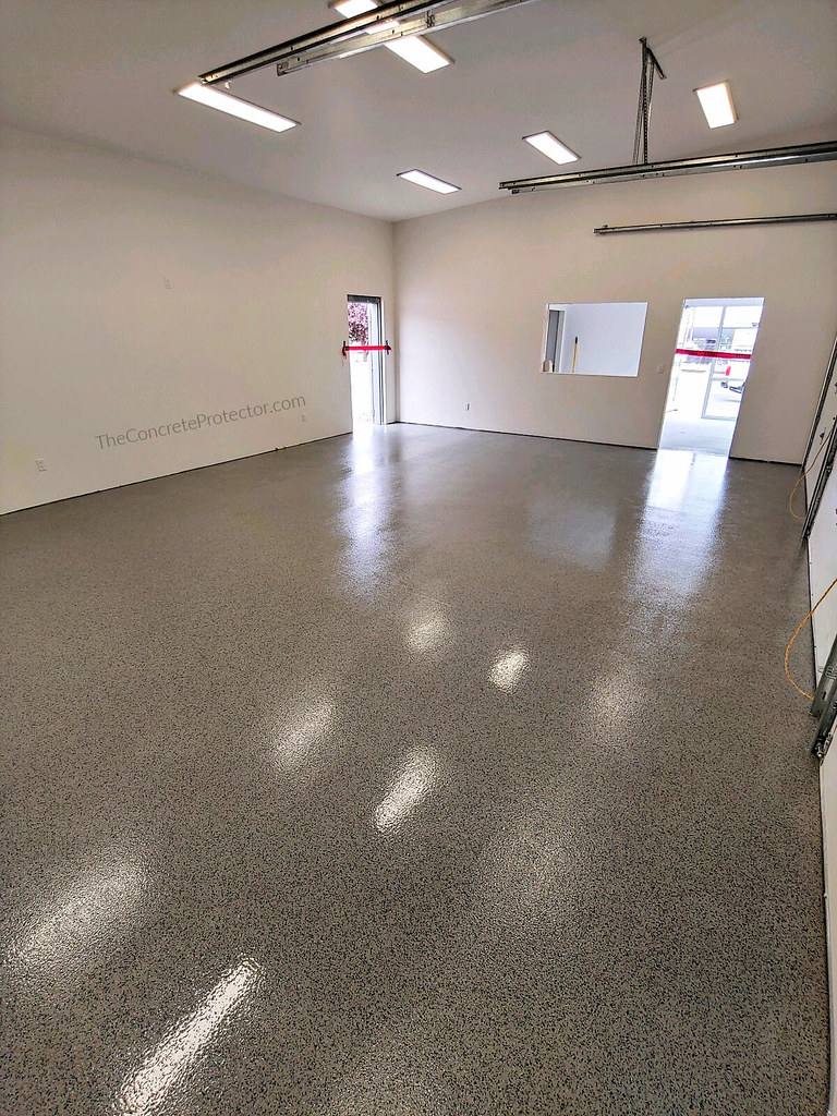 Flake epoxy garage floor beside storage cabinets