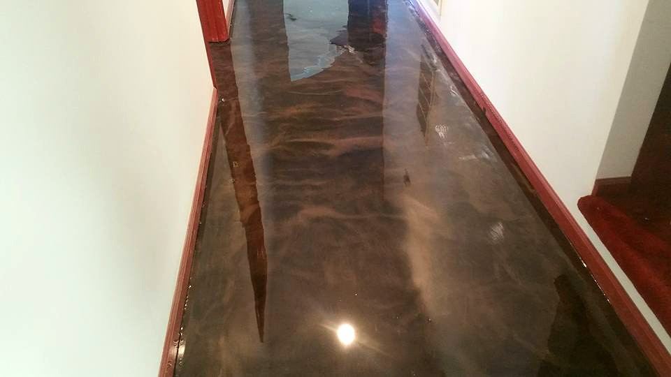 Metallic epoxy floor with copper and brown swirls